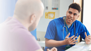 male doctor speaking to male patient about cancer screening