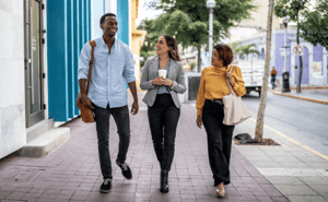 three colleagues walking outside and talking